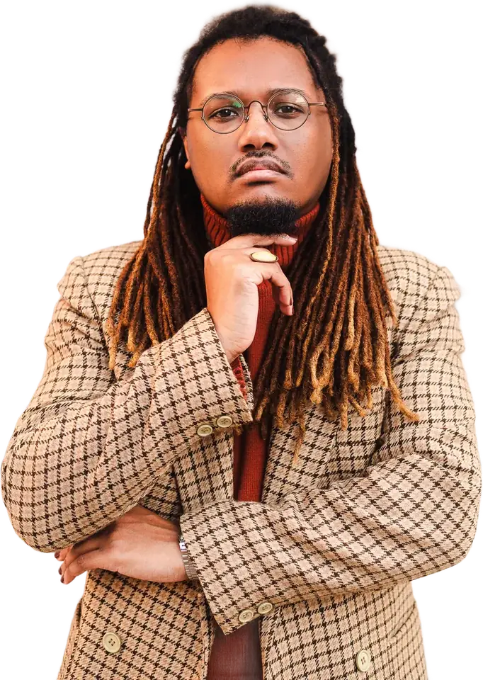 Jonas Davila, wearing round glasses and a houndstooth blazer, hand on chin